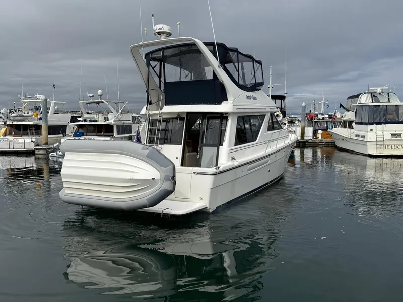 Slide: The Image of 2001 Bayliner 3988 Command Bridge Motoryacht docked in a marina. - 3