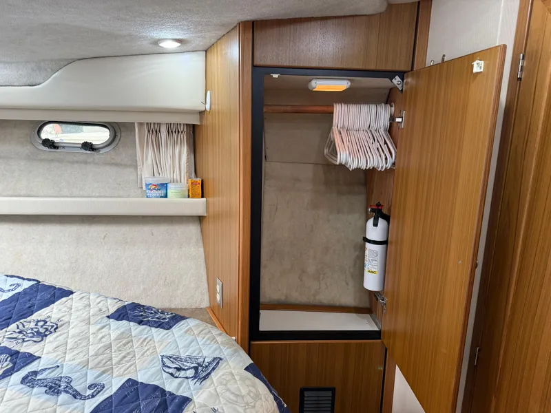 Slide: The Image of 2001 Bayliner 3988 Command Bridge Motoryacht interior with closet, hangers, and fire extinguisher. - 33