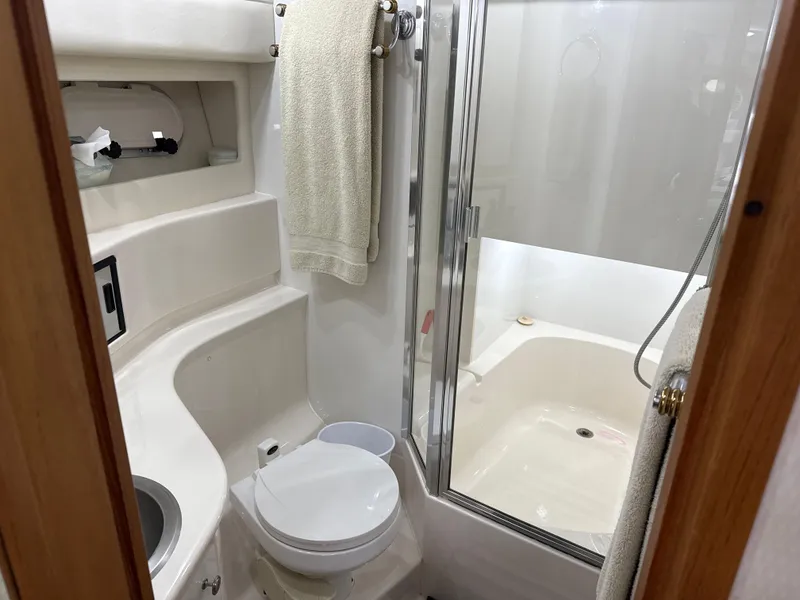 Slide: The Image of Bathroom interior of 2001 Bayliner 3988 Command Bridge Motoryacht, featuring shower and toilet. - 34