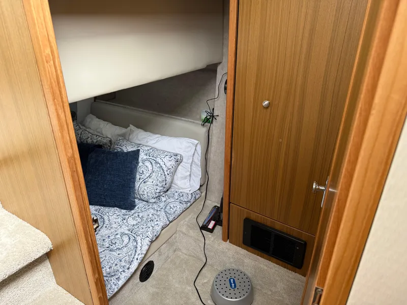 Slide: The Image of Cozy cabin interior of 2001 Bayliner 3988 Command Bridge Motoryacht with bed and wooden paneling. - 36