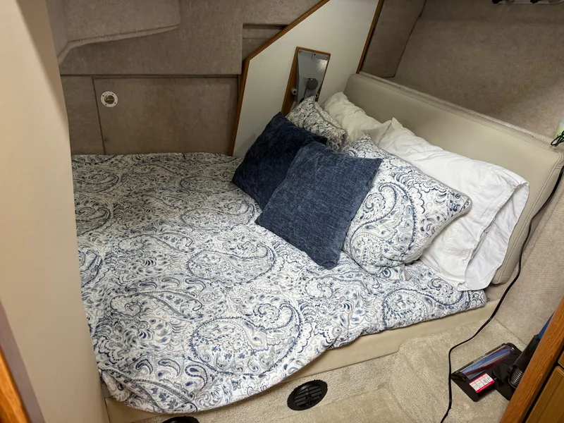Slide: The Image of Cozy bedroom in 2001 Bayliner 3988 Command Bridge Motoryacht with patterned bedding and pillows. - 37