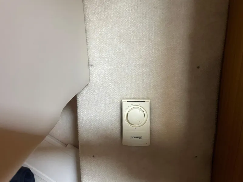 Slide: The Image of Thermostat on Bayliner 3988 Command Bridge Motoryacht, 2001 model, mounted on a carpeted wall. - 39