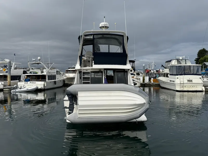 Slide: The Image of 2001 Bayliner 3988 Command Bridge Motoryacht docked in a marina, overcast sky. - 4