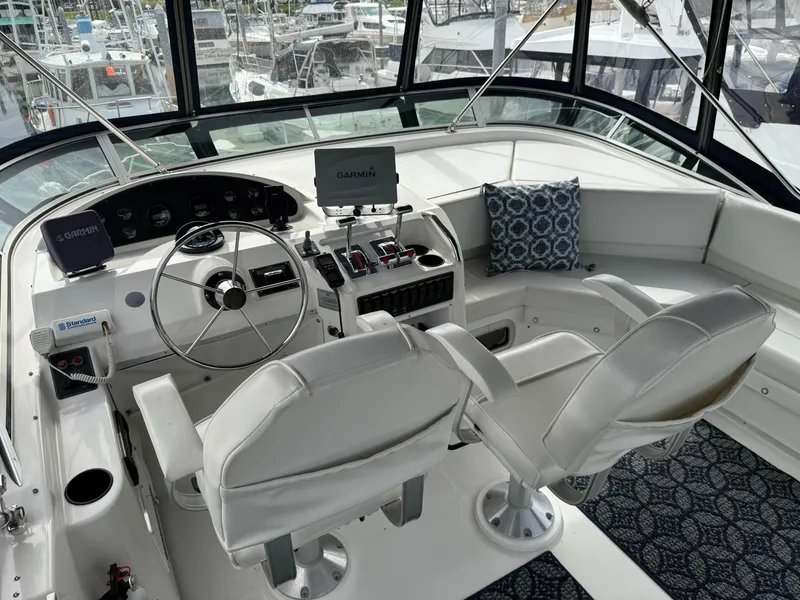 Slide: The Image of 2001 Bayliner 3988 Command Bridge Motoryacht helm with Garmin navigation and plush seating. - 41