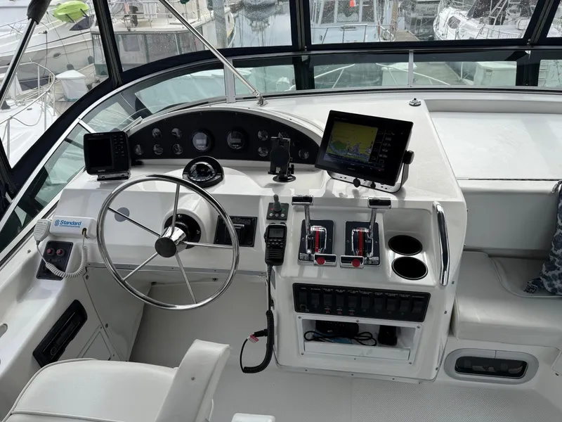 Slide: The Image of 2001 Bayliner 3988 Command Bridge Motoryacht helm with steering wheel, controls, and navigation equipment. - 42