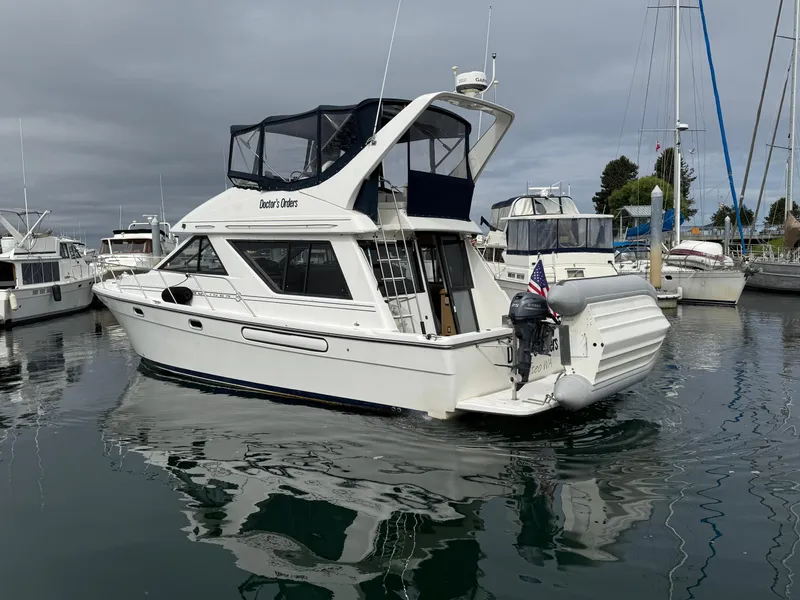 Slide: The Image of 2001 Bayliner 3988 Command Bridge Motoryacht docked in a marina, overcast sky. - 5