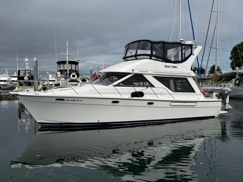 Slide: The Image of 2001 Bayliner 3988 Command Bridge Motoryacht docked in a marina under cloudy skies. - 7