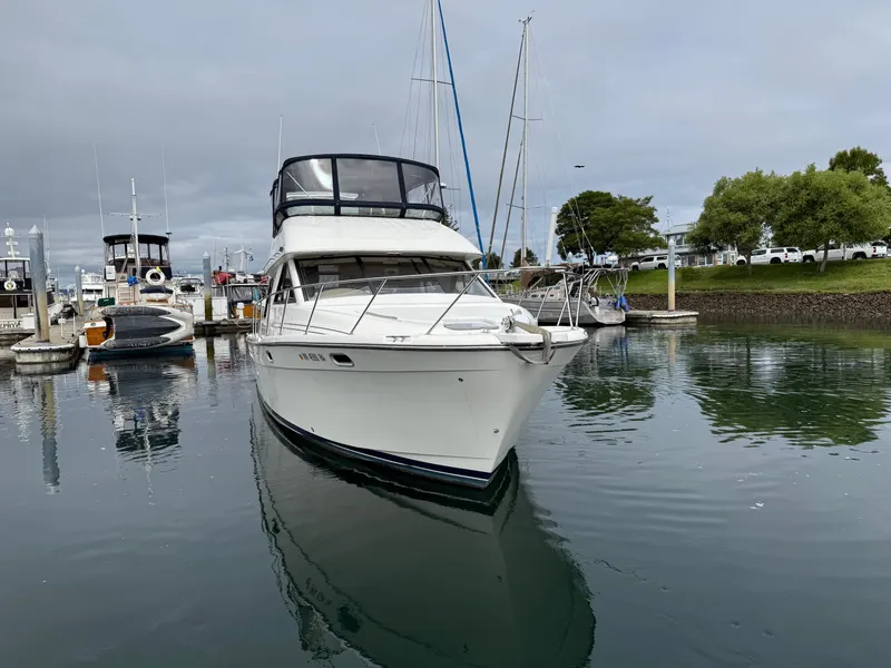Slide: The Image of 2001 Bayliner 3988 Command Bridge Motoryacht docked in a marina, calm water reflection. - 9