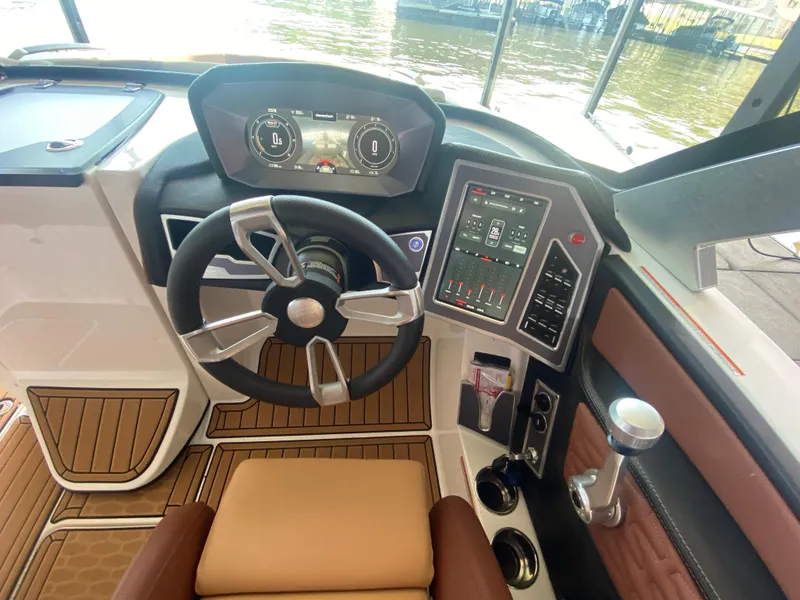 Slide: The Image of 2022 MasterCraft X26 boat dashboard with modern steering wheel and digital controls. - 24