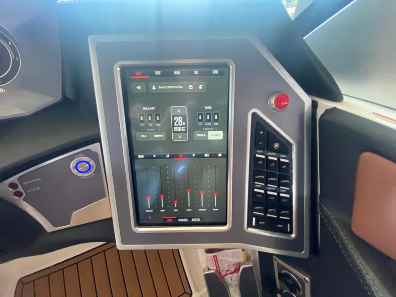 Slide: The Image of 2022 MasterCraft X26 boat dashboard with touchscreen controls and navigation panel. - 26