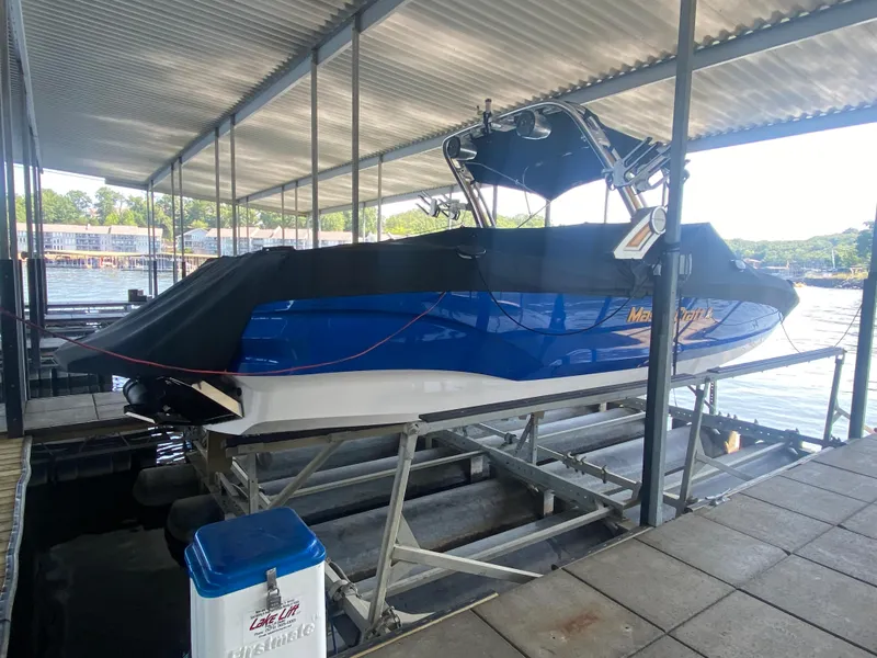 Slide: The Image of 2022 MasterCraft X26 boat docked under a covered marina. - 5