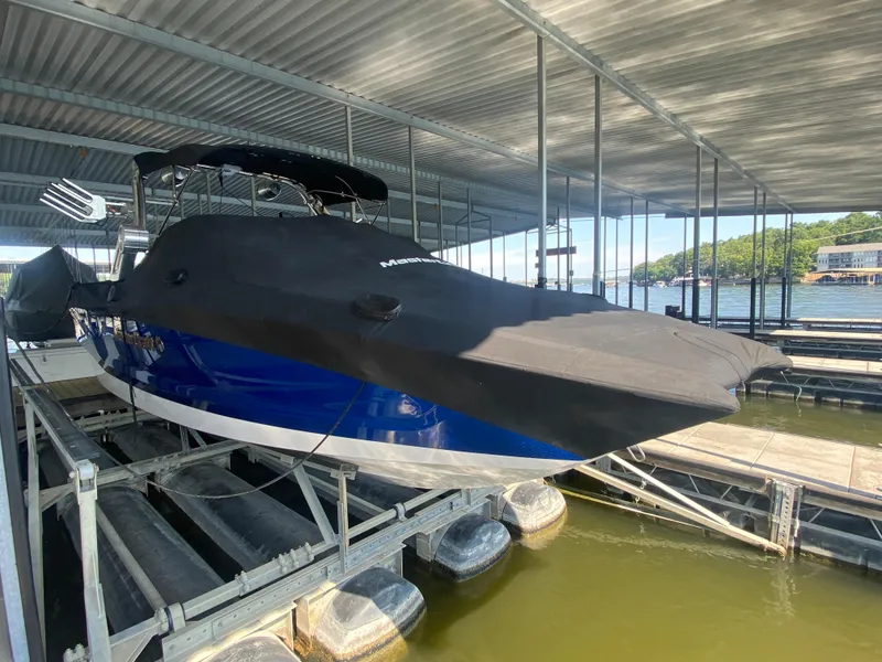 Slide: The Image of 2022 MasterCraft X26 boat covered in dock, blue hull visible. - 6