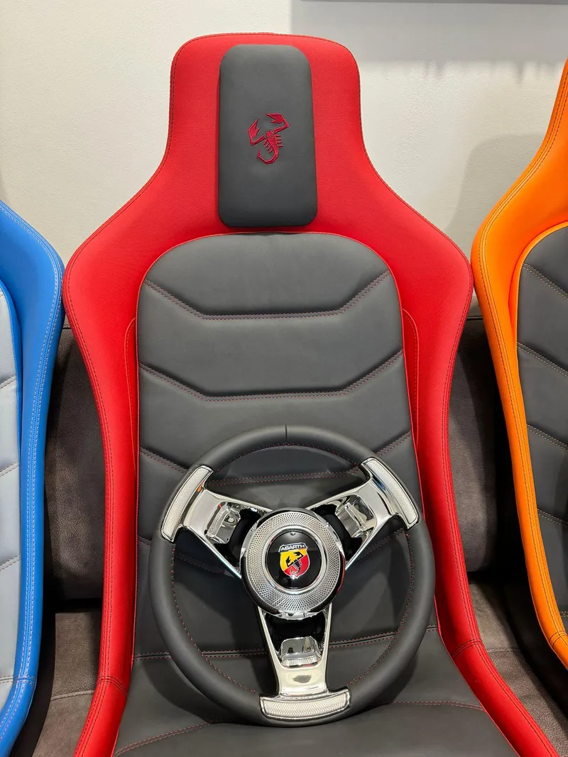 Slide: The Image of Red and black Fiat 500 Abarth seat with steering wheel, 2025 model. - 21
