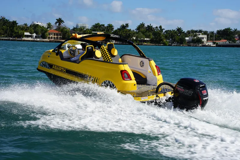 Slide: The Image of 2025 Car Off-shore Fiat 500 Abarth boat cruising on water, vibrant yellow design. - 9