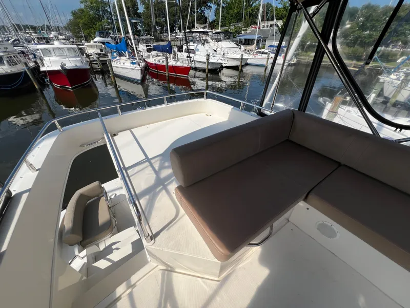 Slide: The Image of 2016 Carver C34 Command Bridge with seating area, docked among other boats. - 14