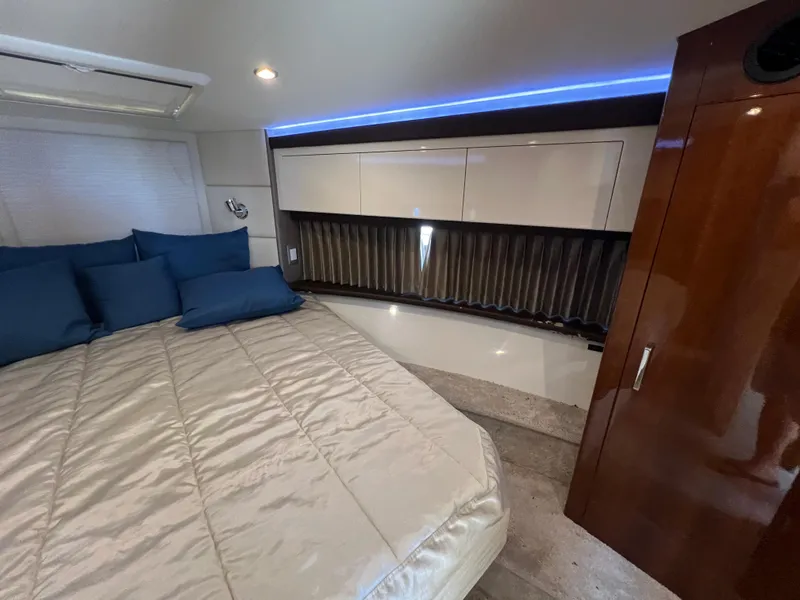 Slide: The Image of Luxurious interior of 2016 Carver C34 Command Bridge with cozy bed and elegant cabinetry. - 16