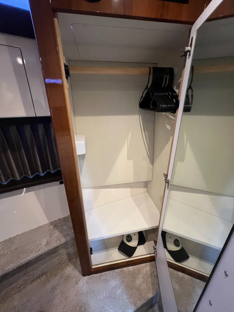 Slide: The Image of Interior closet of 2016 Carver C34 Command Bridge yacht with hangers and mirror. - 17
