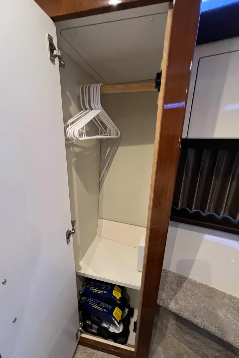 Slide: The Image of Closet interior on 2016 Carver C34 Command Bridge with hangers and storage space. - 21
