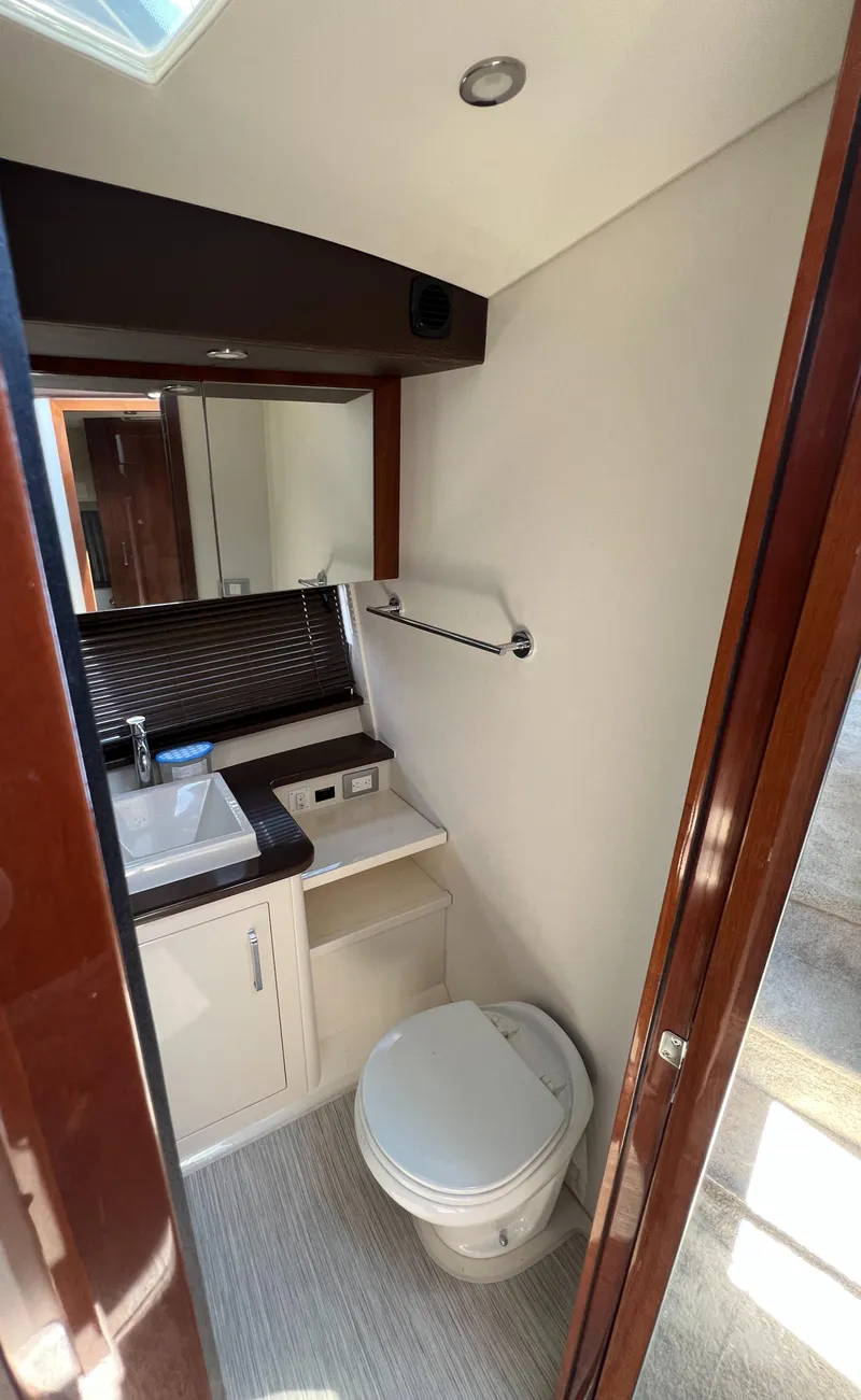 Slide: The Image of Bathroom interior of 2016 Carver C34 Command Bridge yacht, featuring sink and toilet. - 22