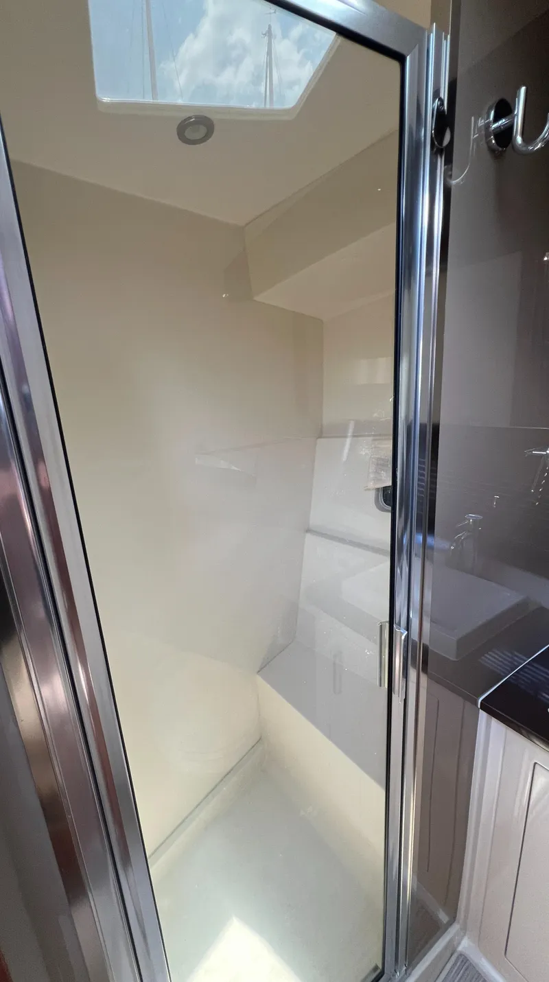 Slide: The Image of Shower area in 2016 Carver C34 Command Bridge yacht with skylight. - 24
