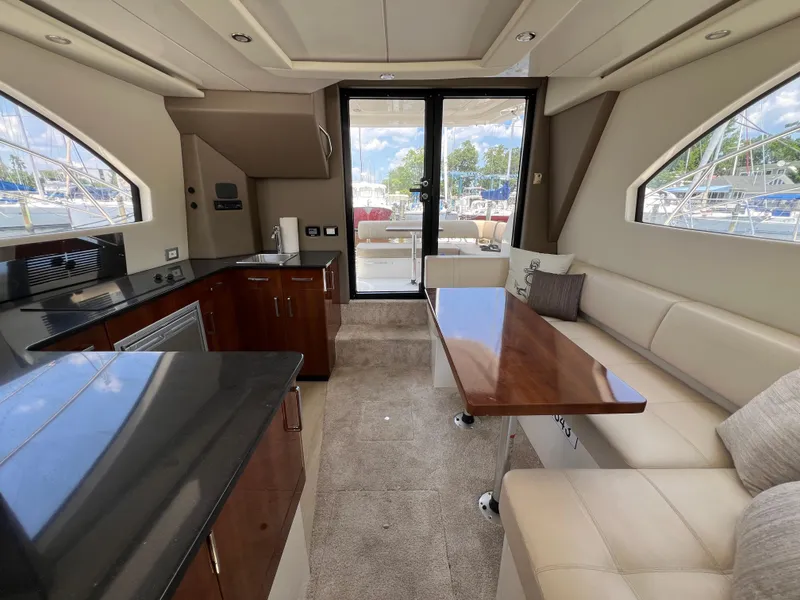Slide: The Image of Luxurious interior of 2016 Carver C34 Command Bridge yacht with modern kitchen and seating area. - 27