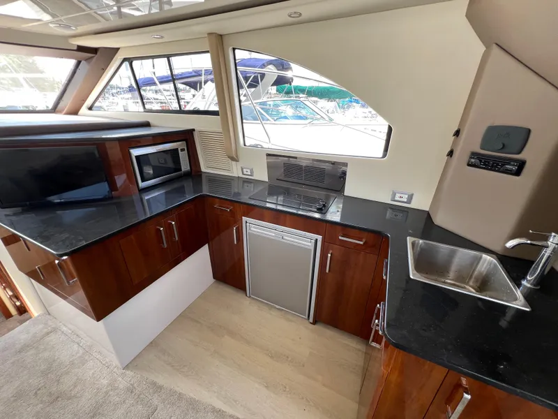 Slide: The Image of Luxurious 2016 Carver C34 Command Bridge yacht kitchen with modern appliances and sleek design. - 29