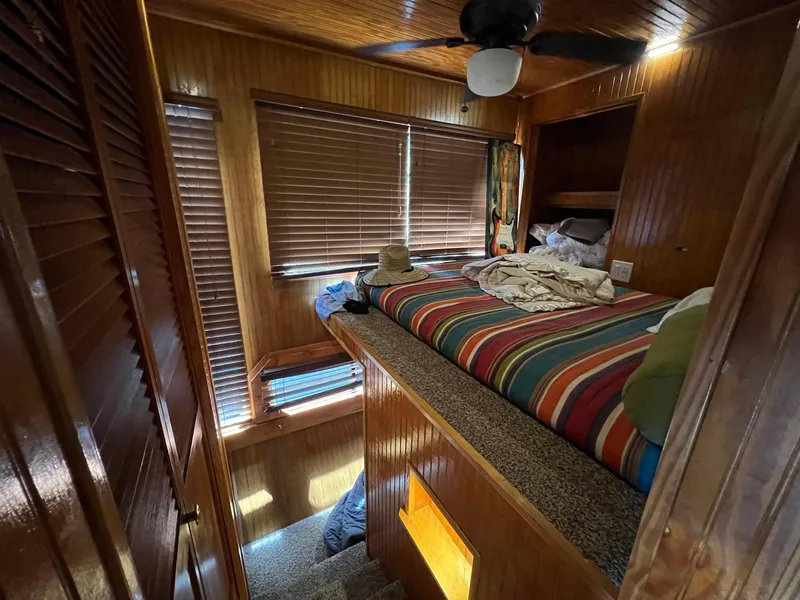 Slide: The Image of Cozy bedroom in 1989 Sumerset houseboat with striped bedding and wooden interior. - 10