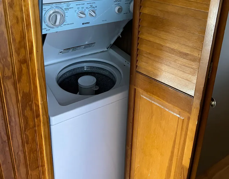 Slide: The Image of Washing machine inside a wooden cabinet on a 1989 Sumerset houseboat. - 11