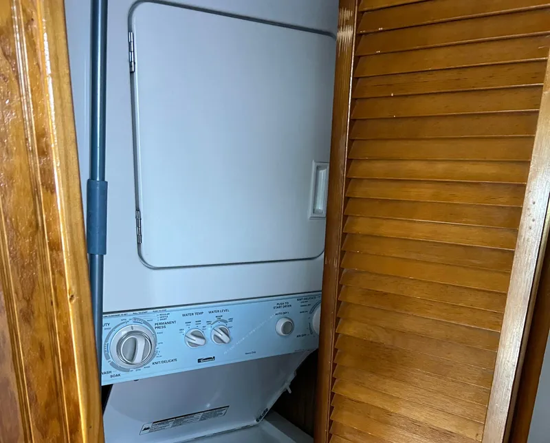 Slide: The Image of Stacked washer and dryer in 1989 Sumerset Houseboat, wooden louvered door. - 12