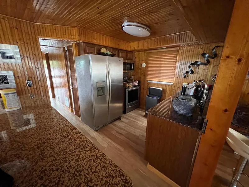 Slide: The Image of Interior of 1989 Sumerset Houseboat kitchen with wood paneling and modern appliances. - 5