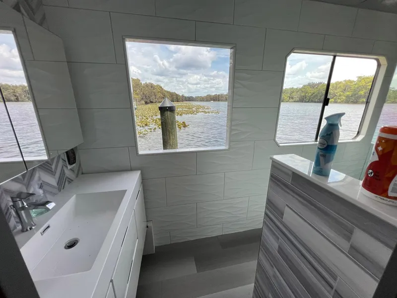 Slide: The Image of Bathroom interior of 1989 Sumerset Houseboat with lake view through windows. - 8