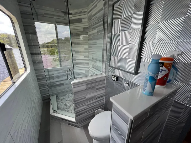 Slide: The Image of Modern bathroom on 1989 Sumerset Houseboat with glass shower and lake view. - 9