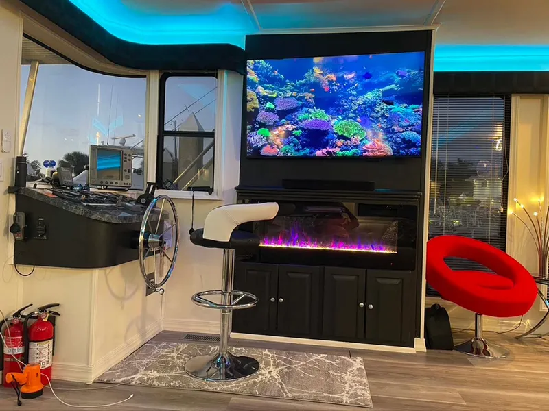 Slide: The Image of Luxurious boat interior with aquarium display, modern seating, and ambient lighting. - 10