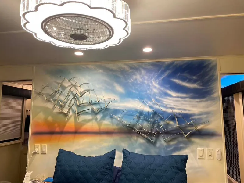 Slide: The Image of Wall art with birds in flight, vibrant sunset sky, and modern chandelier in a Thoroughbred 6516, 2004. - 12