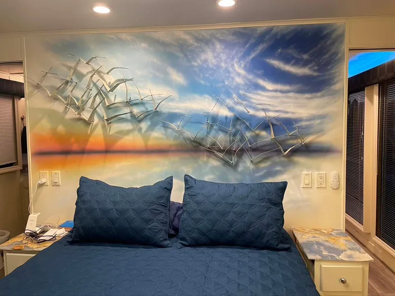 Slide: The Image of Bedroom with blue bedding, artistic wall mural of birds and sky, Thoroughbred 6516, 2004. - 13