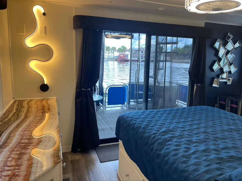 Slide: The Image of Luxurious houseboat bedroom with river view, modern lighting, and elegant decor. Thoroughbred 6516, 2004. - 15