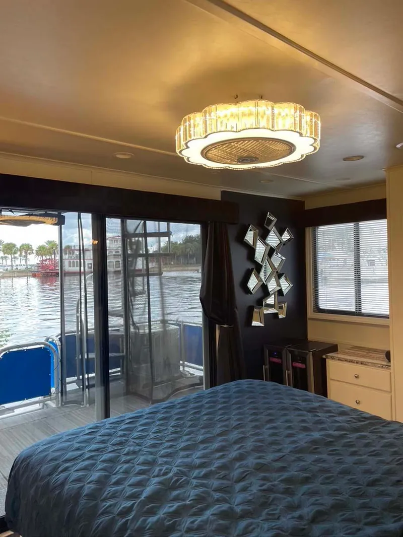 Slide: The Image of Luxurious 2004 Thoroughbred 6516 houseboat bedroom with waterfront view and elegant decor. - 16