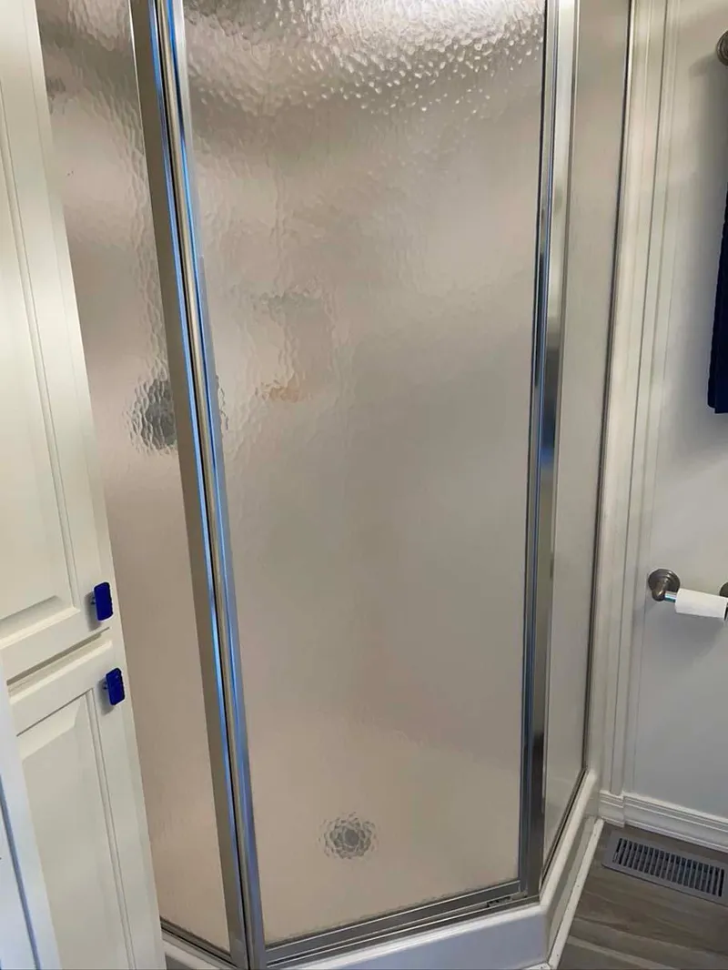 Slide: The Image of Frosted glass shower enclosure with chrome frame in a modern bathroom, Thoroughbred 6516 model. - 19