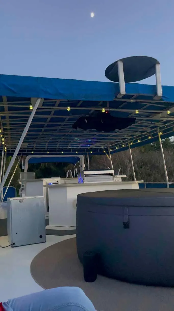 Slide: The Image of 2004 Thoroughbred 6516 boat with canopy and hot tub under evening sky. - 25