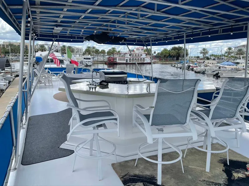 Slide: The Image of Spacious deck of 2004 Thoroughbred 6516 boat with seating and marina view. - 28