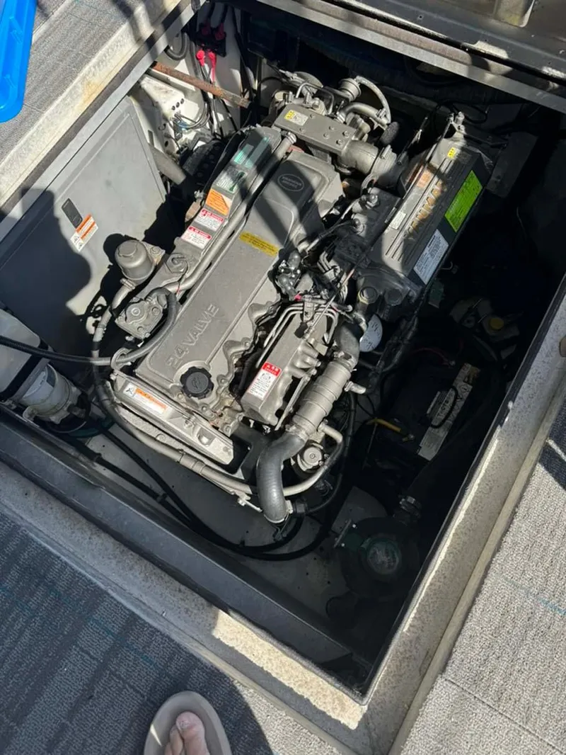 Slide: The Image of Engine compartment of a 2004 Thoroughbred 6516, showcasing detailed mechanical components. - 33