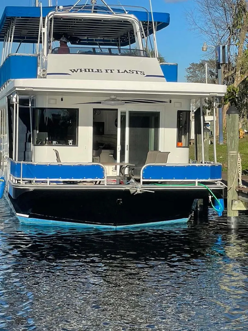 Slide: The Image of Houseboat "While It Lasts," Thoroughbred 6516, 2004 model, docked on a sunny day. - 35