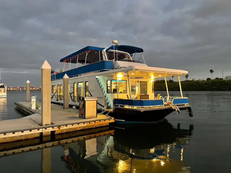 Slide: The Image of Thoroughbred 6516 houseboat docked at sunset, illuminated, 2004 model. - 37