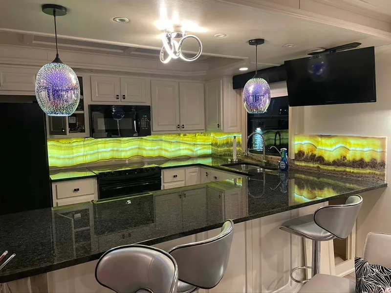 Slide: The Image of Modern kitchen with illuminated onyx backsplash, granite countertops, and stylish pendant lighting. Thoroughbred 6516, 2004. - 8