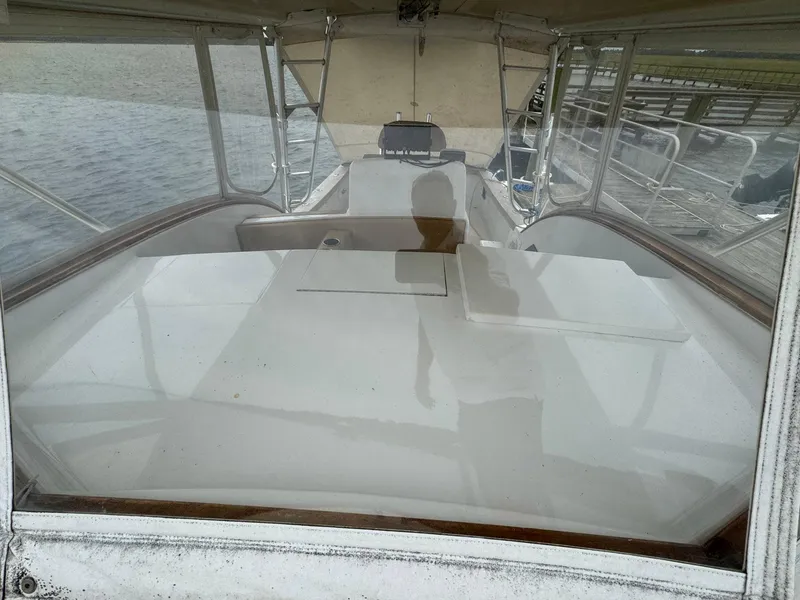 Slide: The Image of 2005 Custom Stardust 32 Express boat interior with clear canopy and water view. - 11