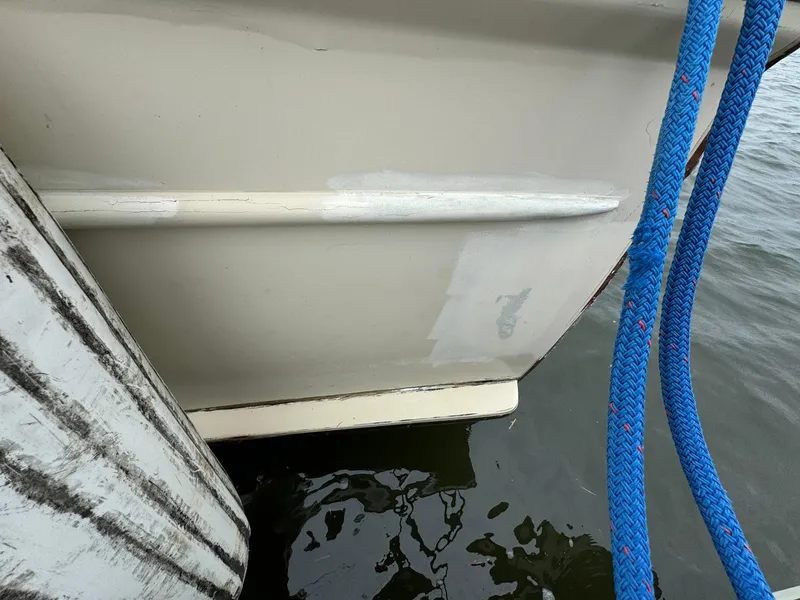 Slide: The Image of Side view of a 2005 Custom Stardust 32 Express boat with blue ropes. - 12