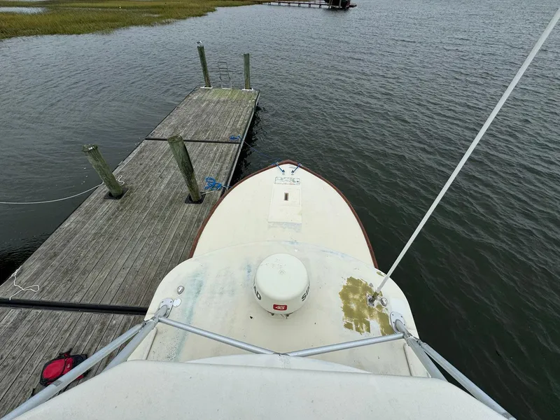 Slide: The Image of Bow view of 2005 Custom Stardust 32 Express docked at a wooden pier. - 14