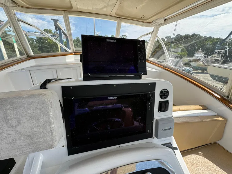 Slide: The Image of Helm of 2005 Custom Stardust 32 Express with Simrad navigation system. - 19