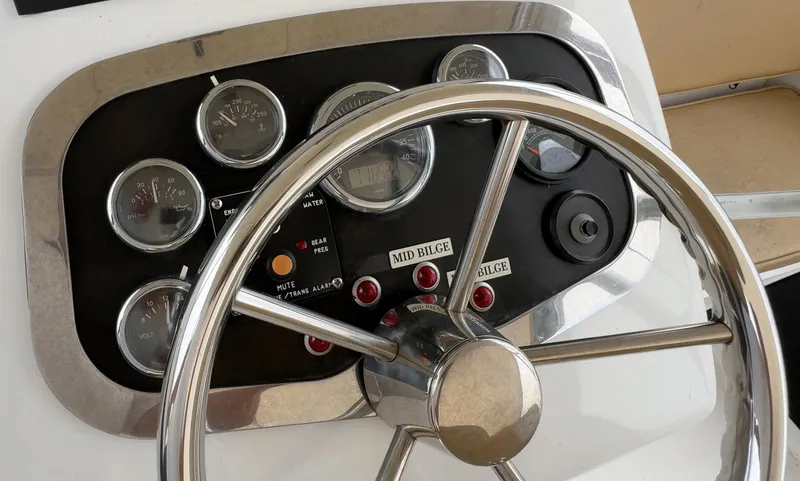 Slide: The Image of Steering wheel and dashboard of 2005 Custom Stardust 32 Express boat. - 21