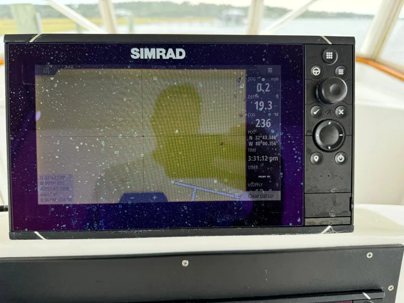 Slide: The Image of Simrad marine GPS display on 2005 Custom Stardust 32 Express boat dashboard. - 24